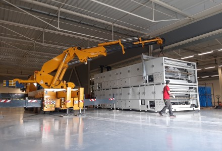 Photos capturing the arrival and installation of heavy industrial equipment at Brite Solar’s new manufacturing facility in Patras.
